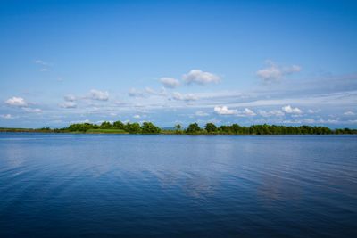 Scenic view of sea against blue sky