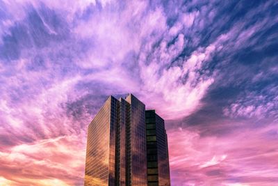 Low angle view of modern building against dramatic sky