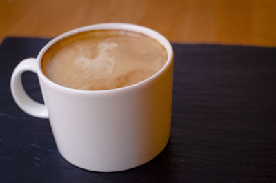 Close-up of coffee cup on table