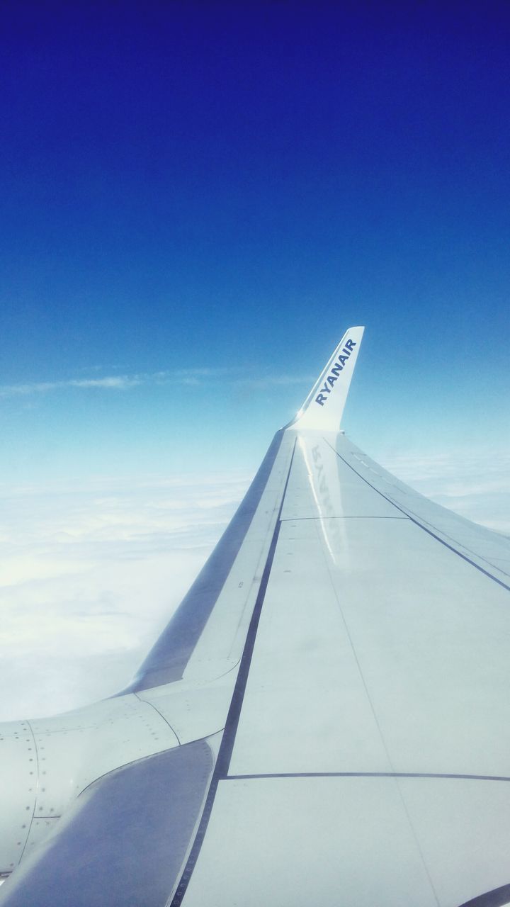 transportation, airplane, blue, part of, aircraft wing, air vehicle, cropped, low angle view, sky, clear sky, copy space, mode of transport, flying, travel, on the move, day, outdoors, no people, journey, built structure