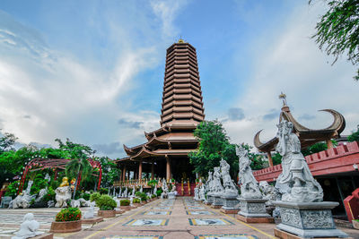 Statues of temple against cloudy sky