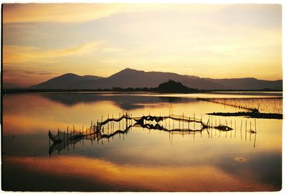 Scenic view of lake against dramatic sky