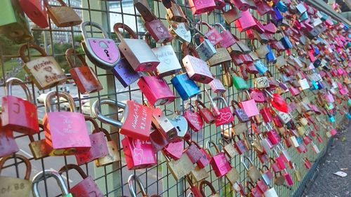 Close-up of padlocks hanging on railing