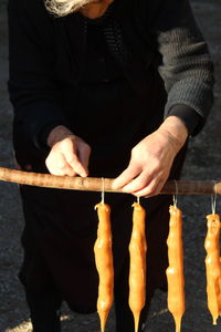 Midsection of man preparing food at market stall