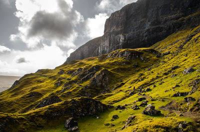 Scenic view of mountains against cloudy sky