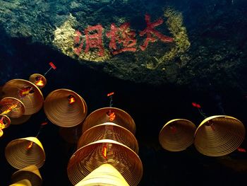 Low angle view of illuminated lanterns hanging at night