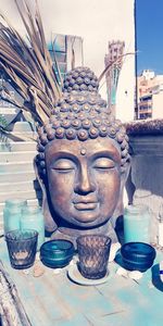 Close-up of buddha statue against building