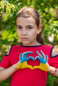 Portrait of cute girl with arms raised