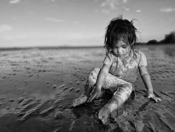 Full length of girl at beach against sky