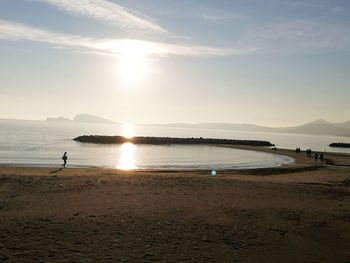 Scenic view of beach against sky during sunset