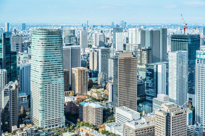 Aerial view of modern buildings in city against sky