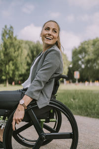 Happy disabled young woman in park