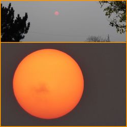 Close-up of illuminated orange ball against sky at sunset