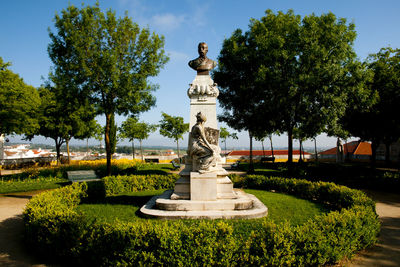 Statue in park against sky