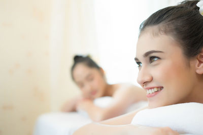 Young woman lying on massage table in spa