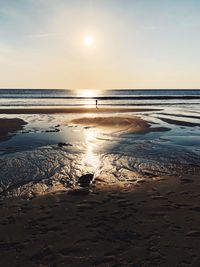 Scenic view of beach against sky during sunset