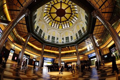 People walking in illuminated railroad station