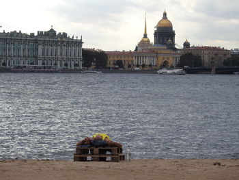 Man lying by river in city