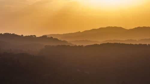 Scenic view of mountains against sky during sunset