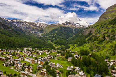 Scenic view of trees and mountains against sky