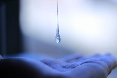 Close-up of water drop on hand