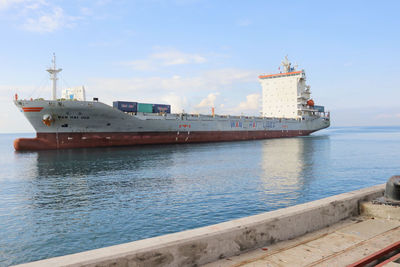 Ship sailing on sea against sky