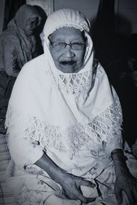 Portrait of a smiling woman sitting outdoors