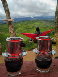 Close-up of red tea on table against sky