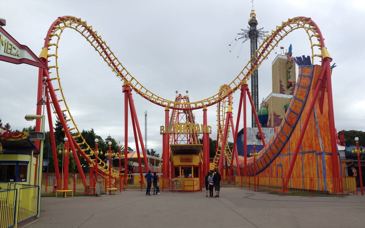 built structure, architecture, building exterior, amusement park, sky, amusement park ride, arts culture and entertainment, ferris wheel, incidental people, travel destinations, low angle view, famous place, leisure activity, outdoors, tourism, men, travel, metal, day