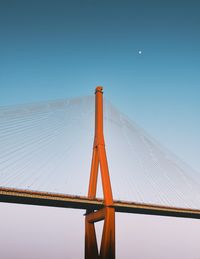 Low angle view of cable-stayed bridge against clear blue sky