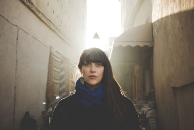 Woman standing on narrow street