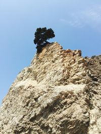 Low angle view of cliff against sky