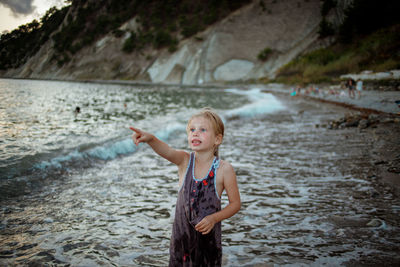 Happy girl standing in water