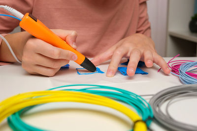 Teen girl using 3d pen. robotics. steam, stem education. modern technologies. play and study at home