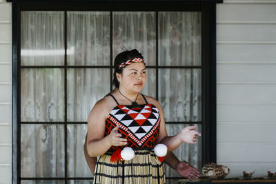 Full length portrait of woman standing outdoors