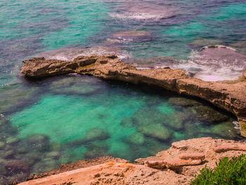 High angle view of rocks by sea