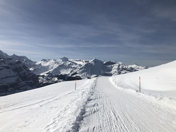 Scenic view of snow covered mountains against sky