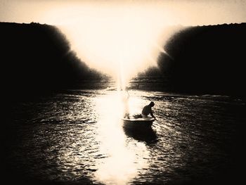 Boat sailing in sea at sunset