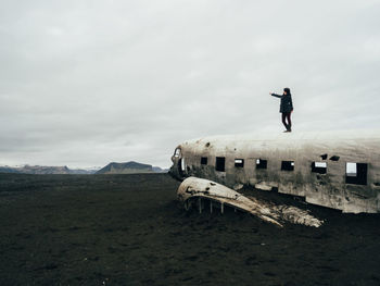 Man standing on landscape against sky