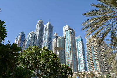 Low angle view of skyscrapers against clear sky