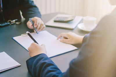 Midsection of business coworkers working in office