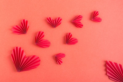 Monochrome red background with flying origami hearts. st. valentine's day