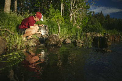 Young man at camping at lakeside