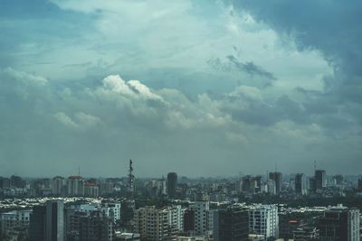 Cityscape against cloudy sky