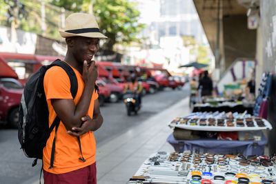 Man standing on street in city