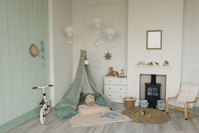 White fabric teepee and scandinavian simple decor in the interior of the children's room.