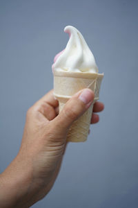 Close-up of hand holding ice cream cone