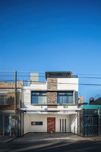 Low angle view of building against clear blue sky