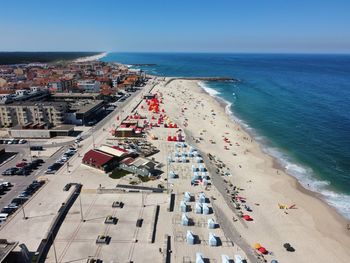 High angle view of townscape by sea against sky