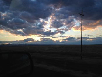 Silhouette landscape against sky during sunset